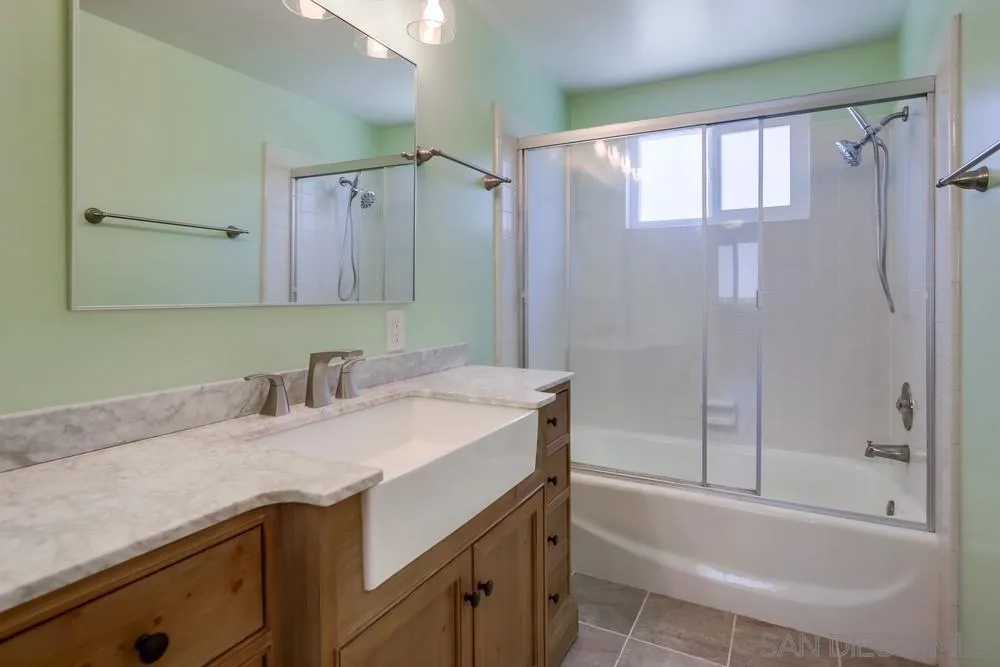 7568 Ohio Place La Mesa, CA 91942 - Photo 16 of 32 a bathroom with a granite countertop sink toilet and shower