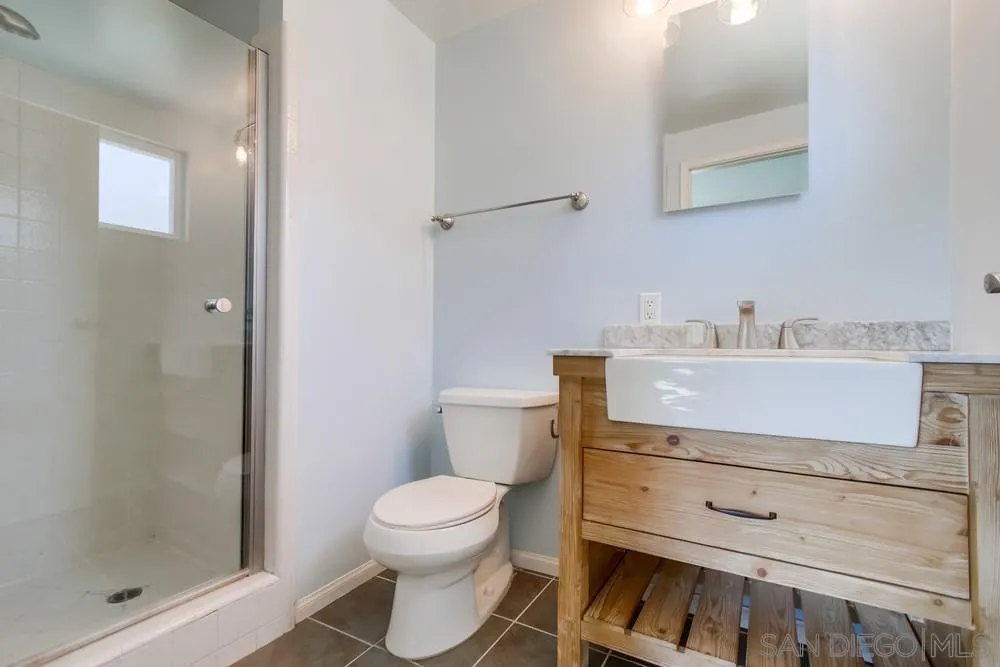 7568 Ohio Place La Mesa, CA 91942 - Photo 17 of 32 a bathroom with a sink toilet and shower