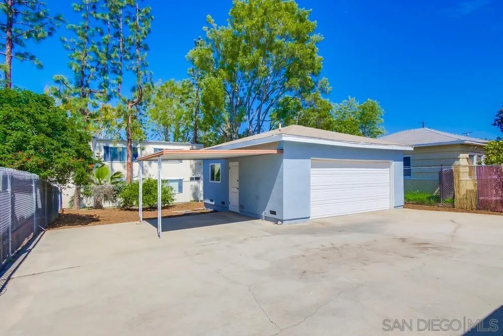 7568 Ohio Place La Mesa, CA 91942 - Photo 26 of 32 a view of a house with a yard and garage