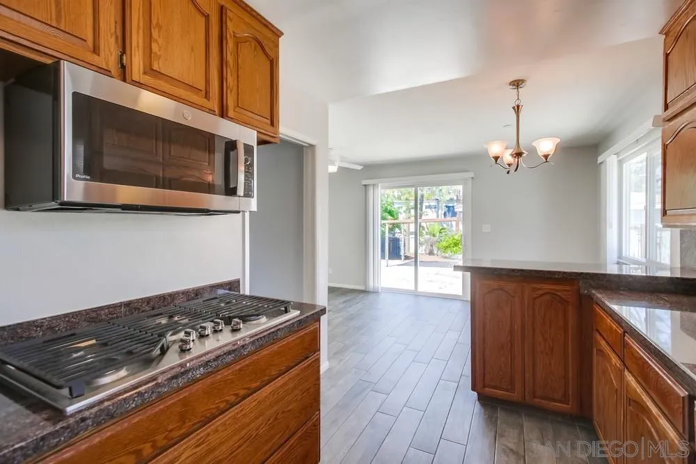 7568 Ohio Place La Mesa, CA 91942 - Photo 9 of 32 a kitchen with a stove and a microwave