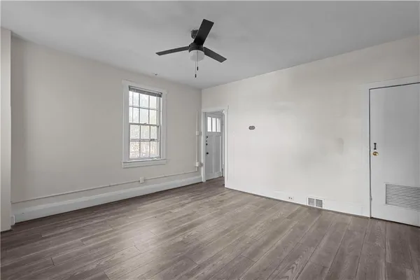 wooden floor in an empty room with a window