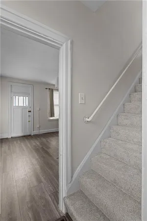 an empty room with a window and a ceiling fan