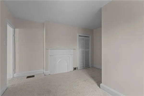 a view of a room with wooden floor and a sink