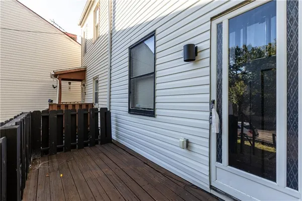 a view of a balcony with furniture and wooden floor