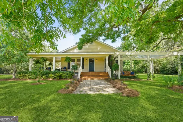 a front view of a house with a garden and porch