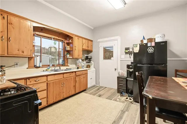 a kitchen with stainless steel appliances a sink and cabinets