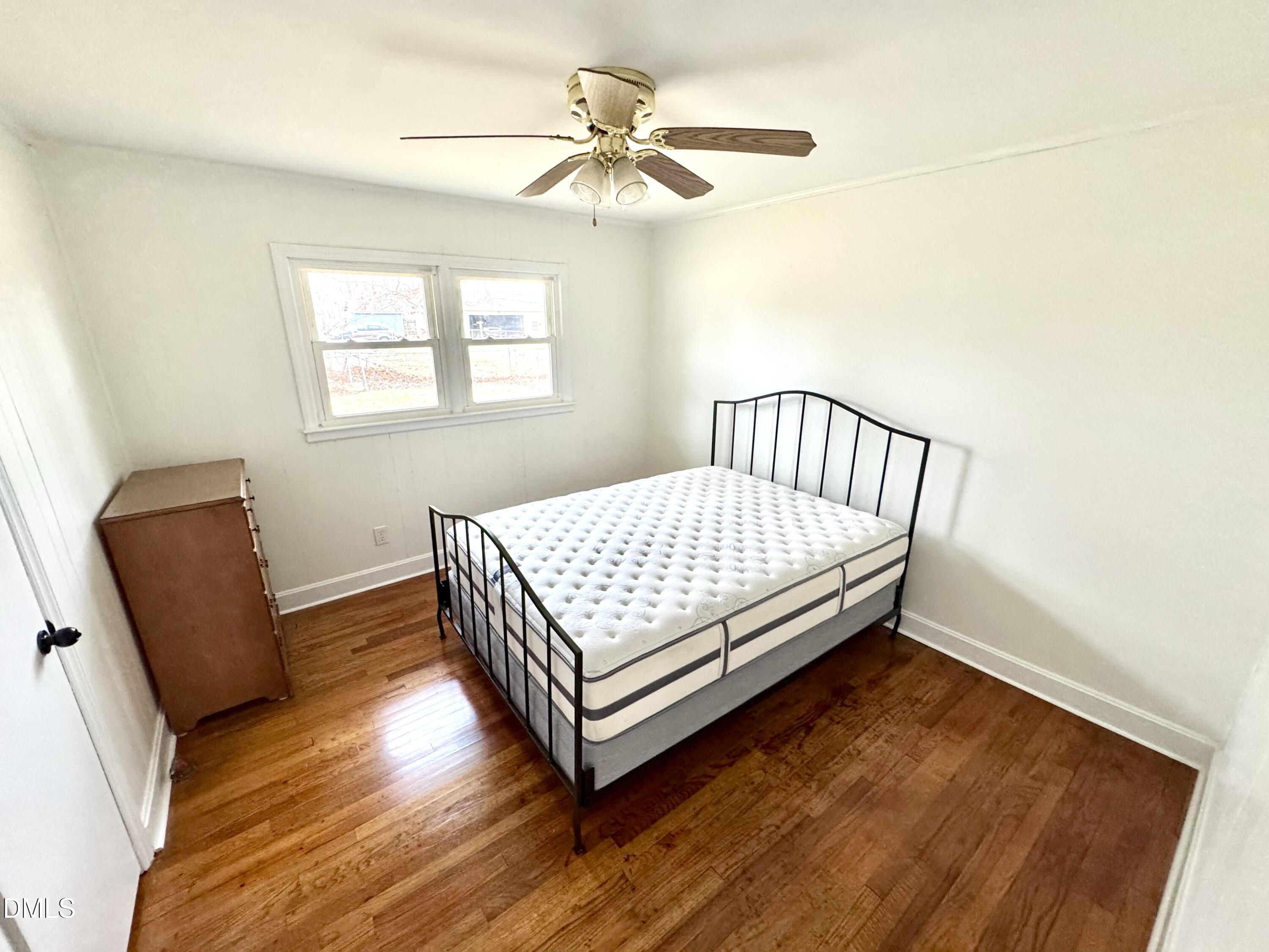 30 Nandina Drive Roxboro, NC 27573 - Photo 16 of 31 a bedroom with a bed and wooden floor