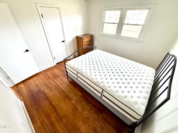 a bedroom with wooden floor