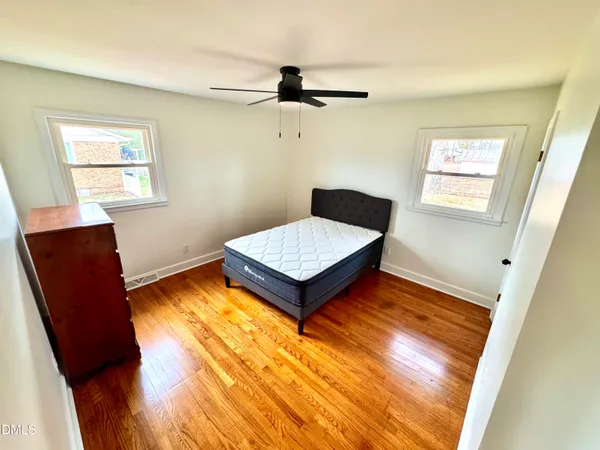 a living room with baby crib furniture and a window