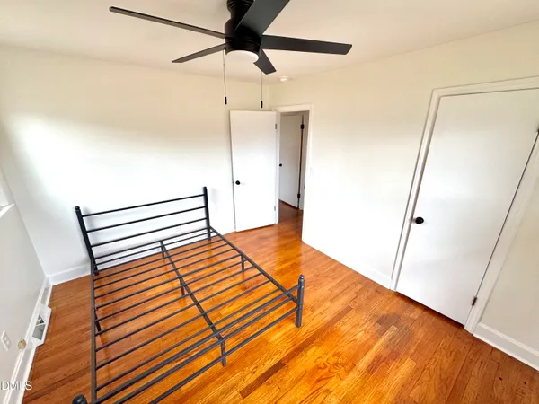 a view of a room with wooden floor