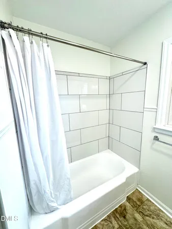 a bathroom with a shower and a tub