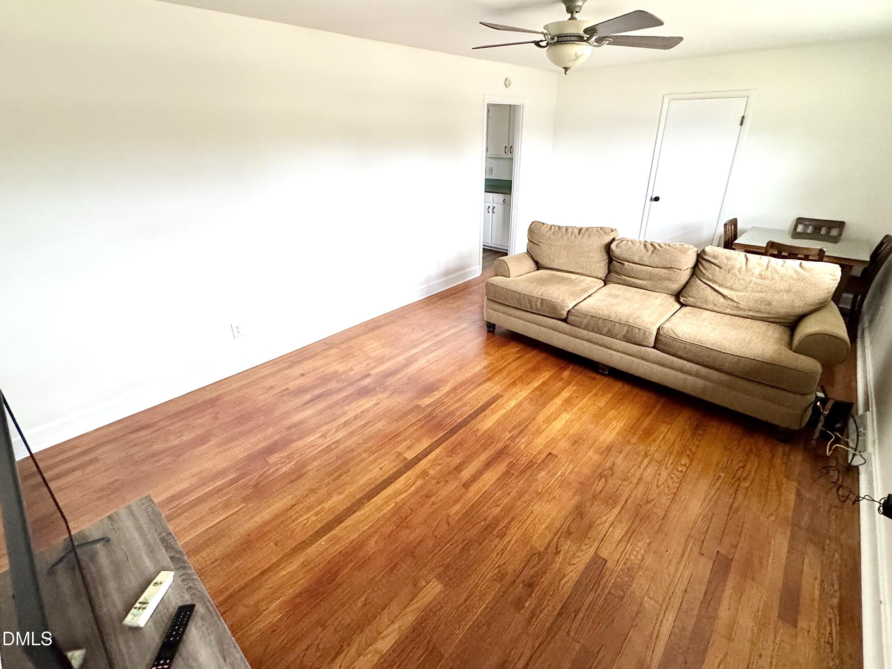 30 Nandina Drive Roxboro, NC 27573 - Photo 26 of 31 a living room with a bed furniture and a wooden floor