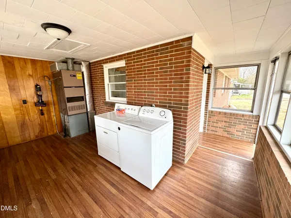 a view of a livingroom with furniture wooden floor and window