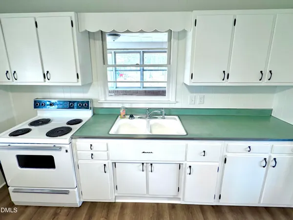 a kitchen with a cabinets and white appliances