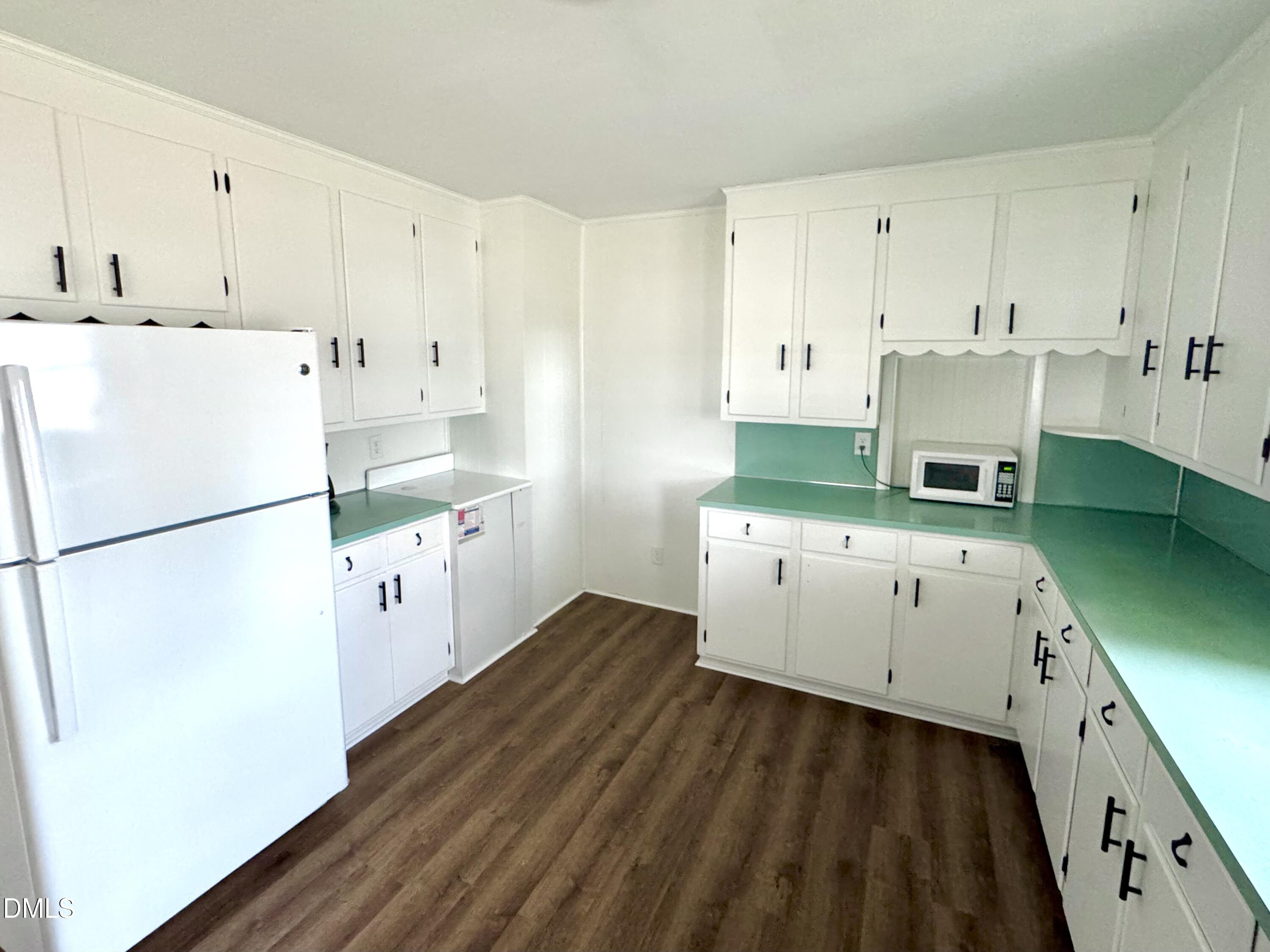 30 Nandina Drive Roxboro, NC 27573 - Photo 8 of 31 a kitchen with cabinets a refrigerator and a stove