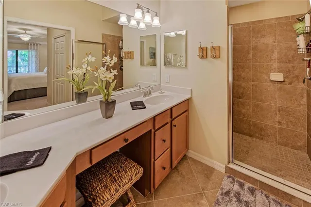 a bathroom with a sink a mirror and a shower