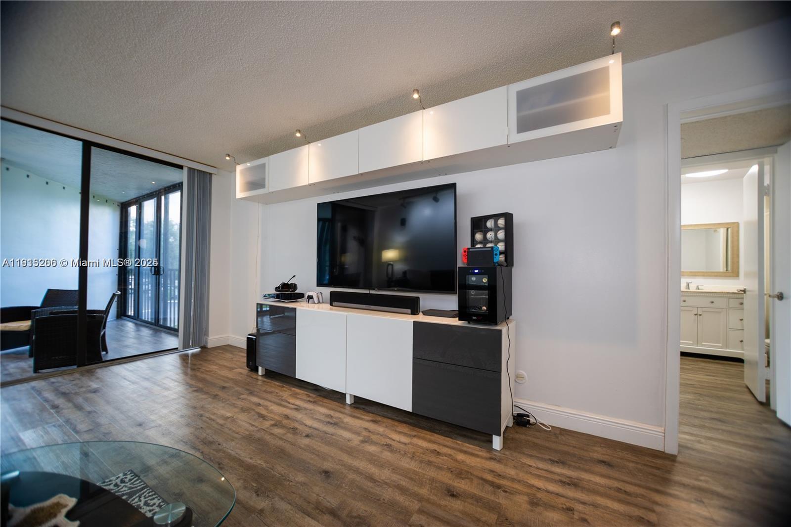 16100 Golf Club Road, Unit 202 Weston, FL 33326 - Photo 11 of 31 a living room with furniture and a flat screen tv