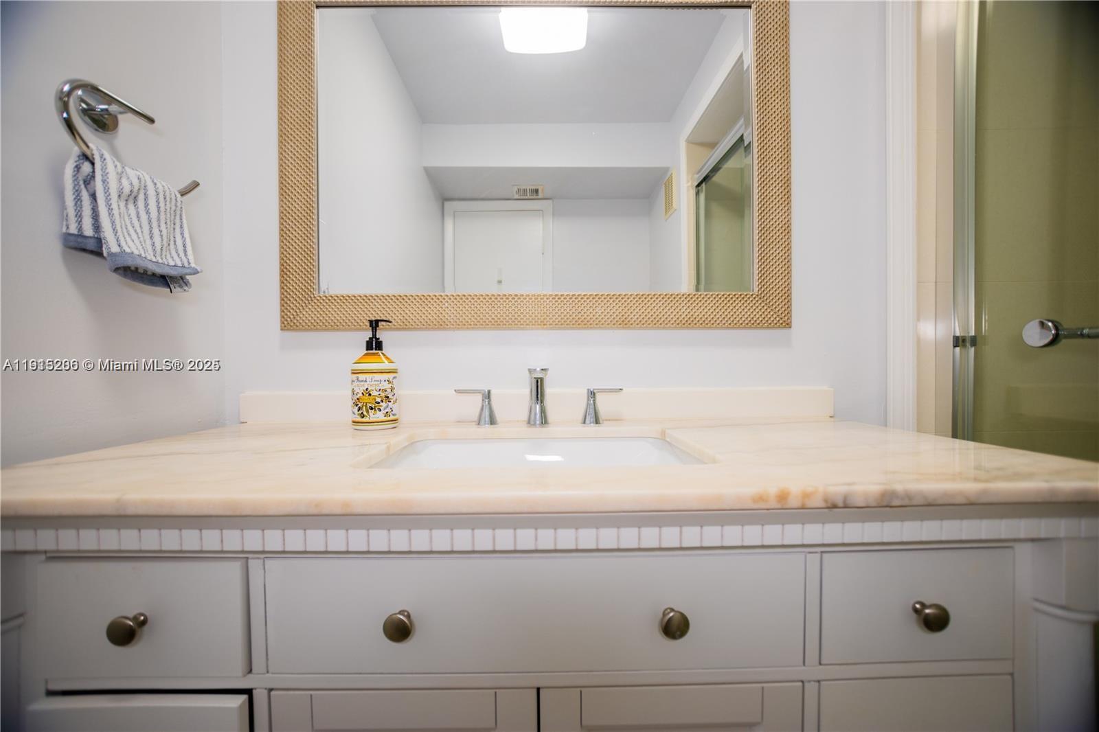 16100 Golf Club Road, Unit 202 Weston, FL 33326 - Photo 20 of 31 a bathroom with a sink and a mirror