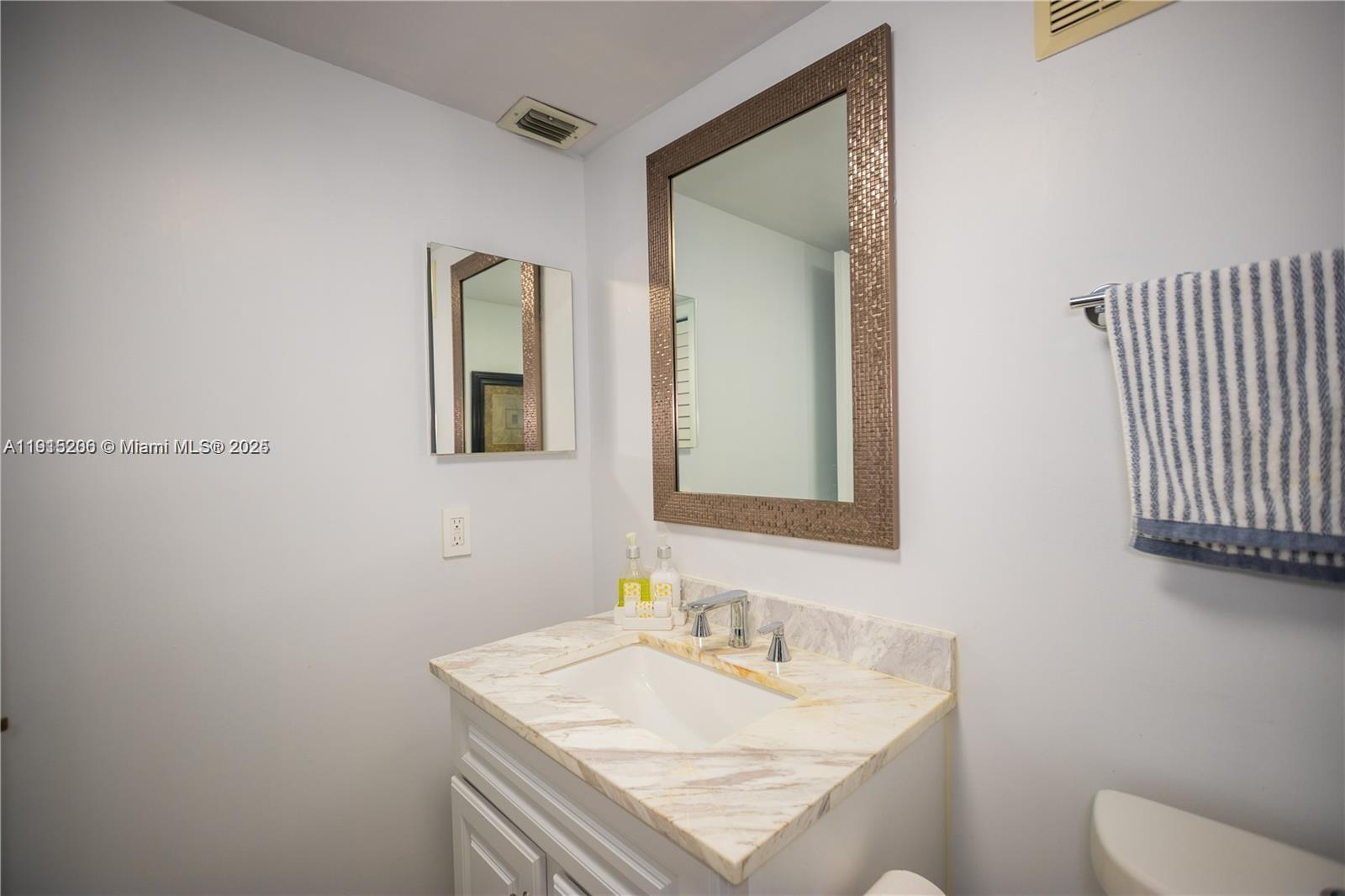 16100 Golf Club Road, Unit 202 Weston, FL 33326 - Photo 23 of 31 a bathroom with a sink toilet and mirror