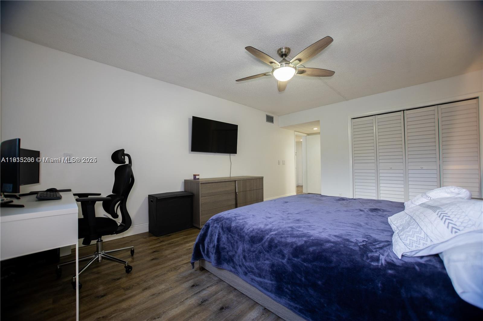 16100 Golf Club Road, Unit 202 Weston, FL 33326 - Photo 25 of 31 a bedroom with a bed and a flat screen tv