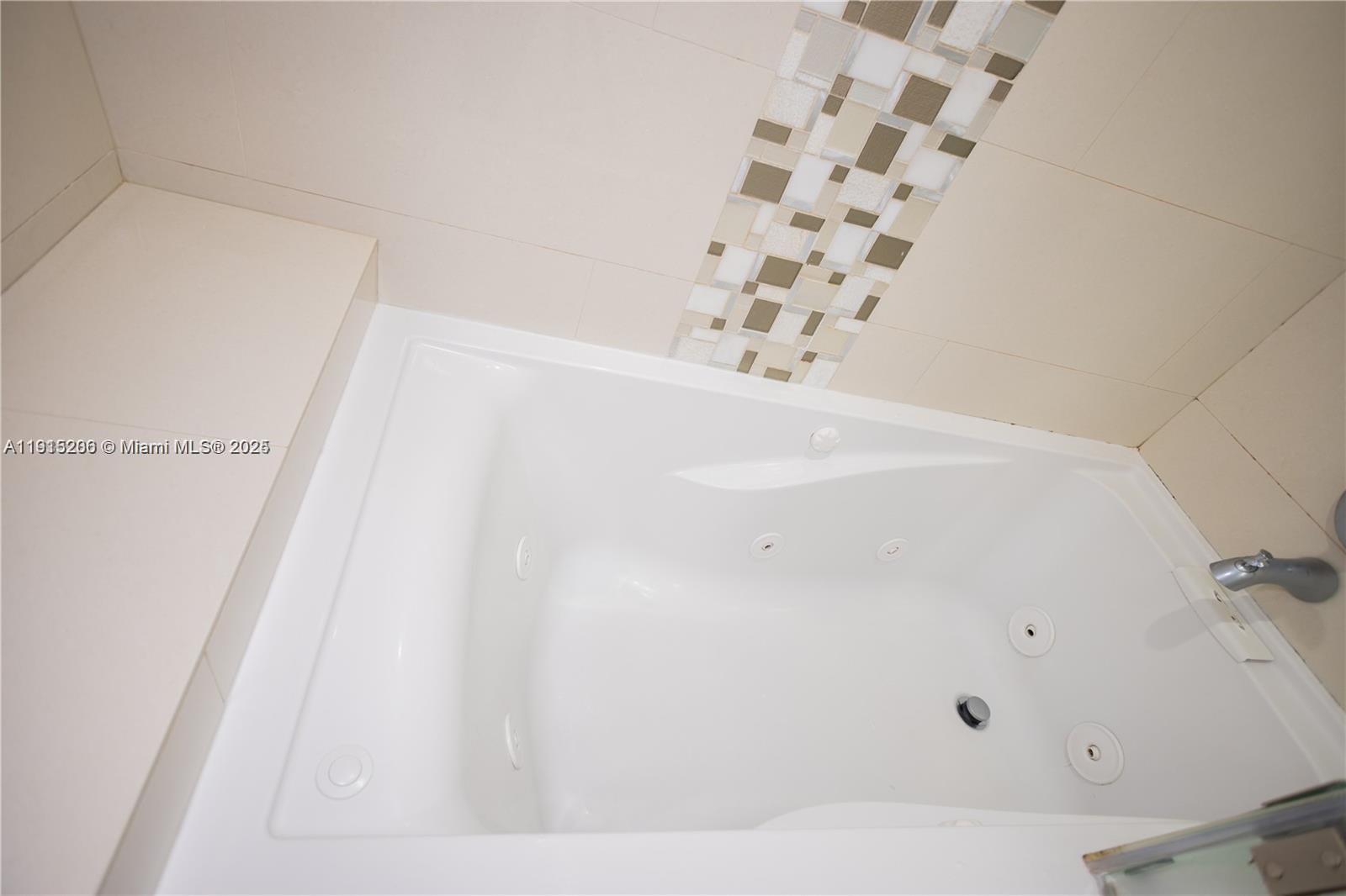 16100 Golf Club Road, Unit 202 Weston, FL 33326 - Photo 28 of 31 a bathroom with a bathtub