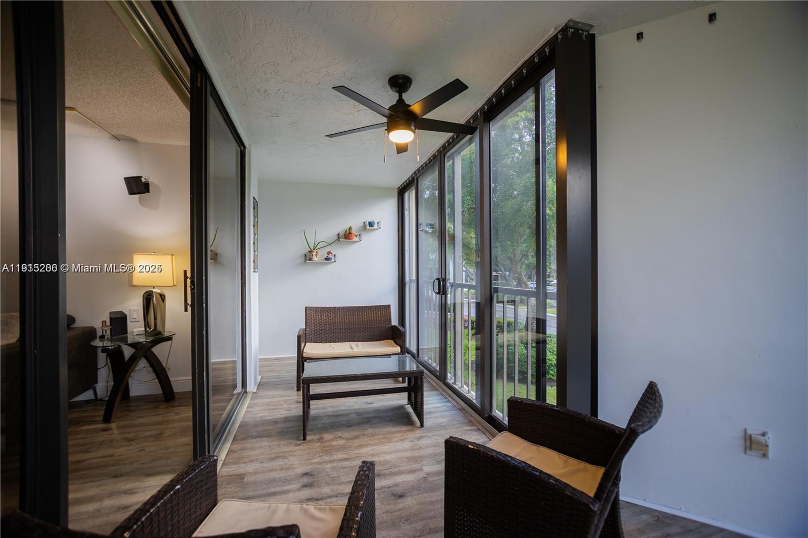 16100 Golf Club Road, Unit 202 Weston, FL 33326 - Photo 7 of 31 a living room with furniture and a gate