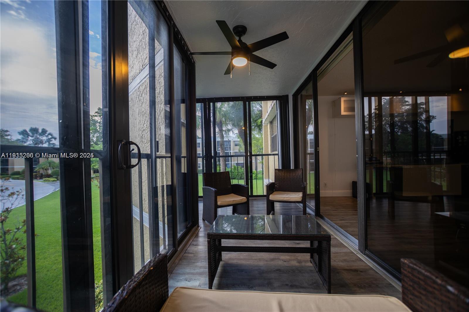 16100 Golf Club Road, Unit 202 Weston, FL 33326 - Photo 9 of 31 a view of a porch with chairs