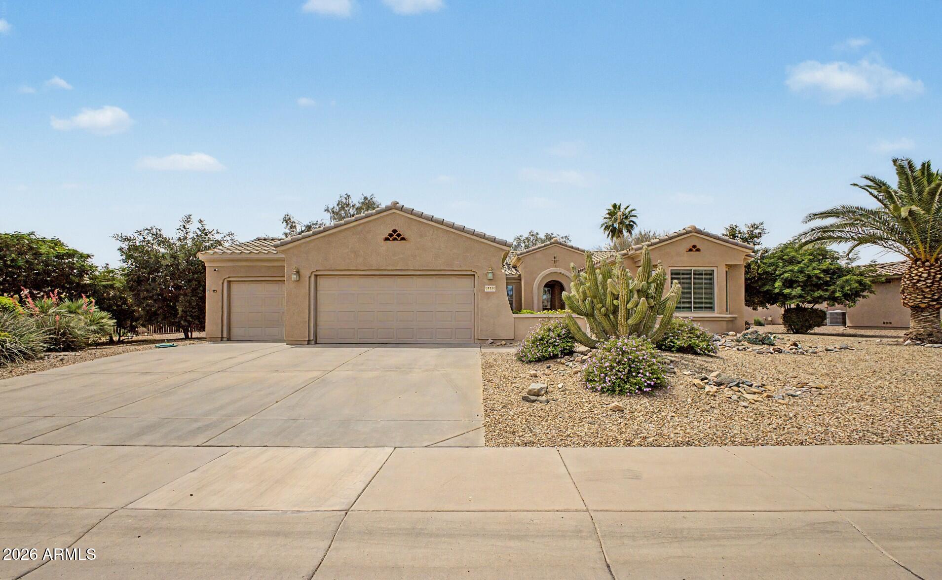 16731 West Oracle Rim Drive Surprise, AZ 85387 - Photo 1 of 54 a front view of a house with a yard and garage
