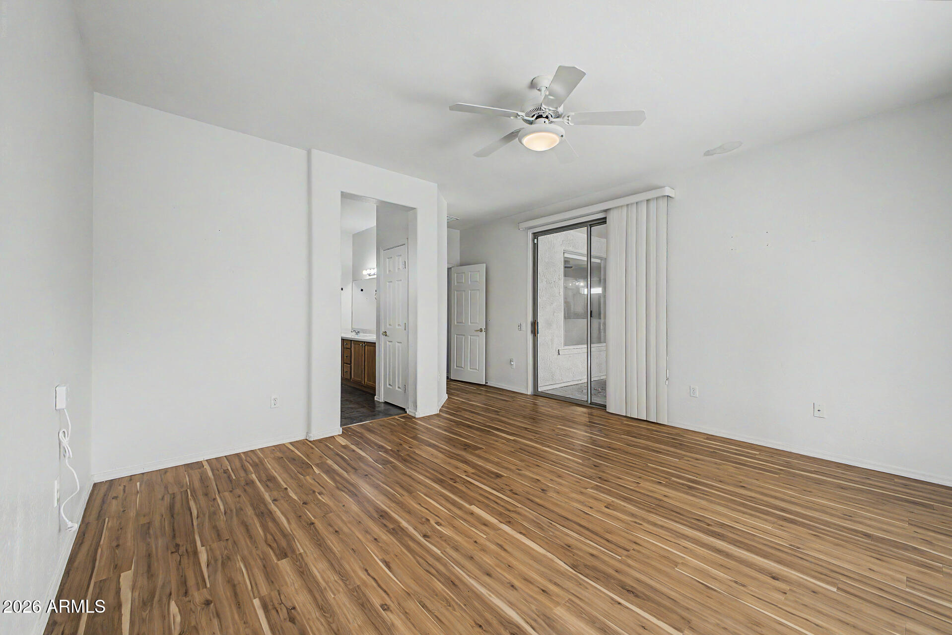16731 West Oracle Rim Drive Surprise, AZ 85387 - Photo 12 of 54 a view of an empty room with wooden floor