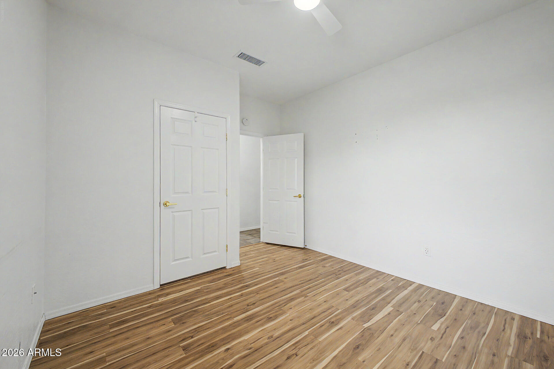 16731 West Oracle Rim Drive Surprise, AZ 85387 - Photo 17 of 54 a view of empty room with wooden floor
