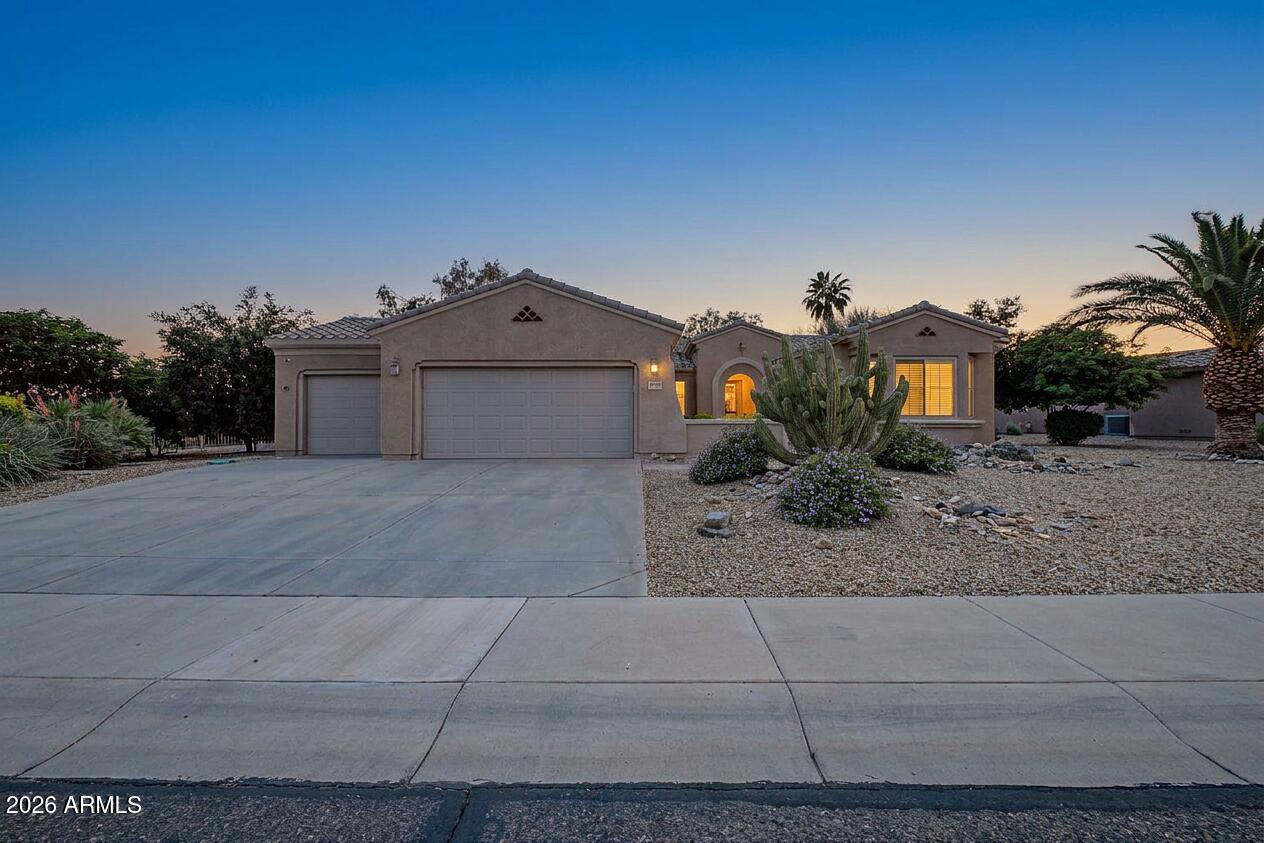 16731 West Oracle Rim Drive Surprise, AZ 85387 - Photo 2 of 54 a front view of a house with a yard and garage