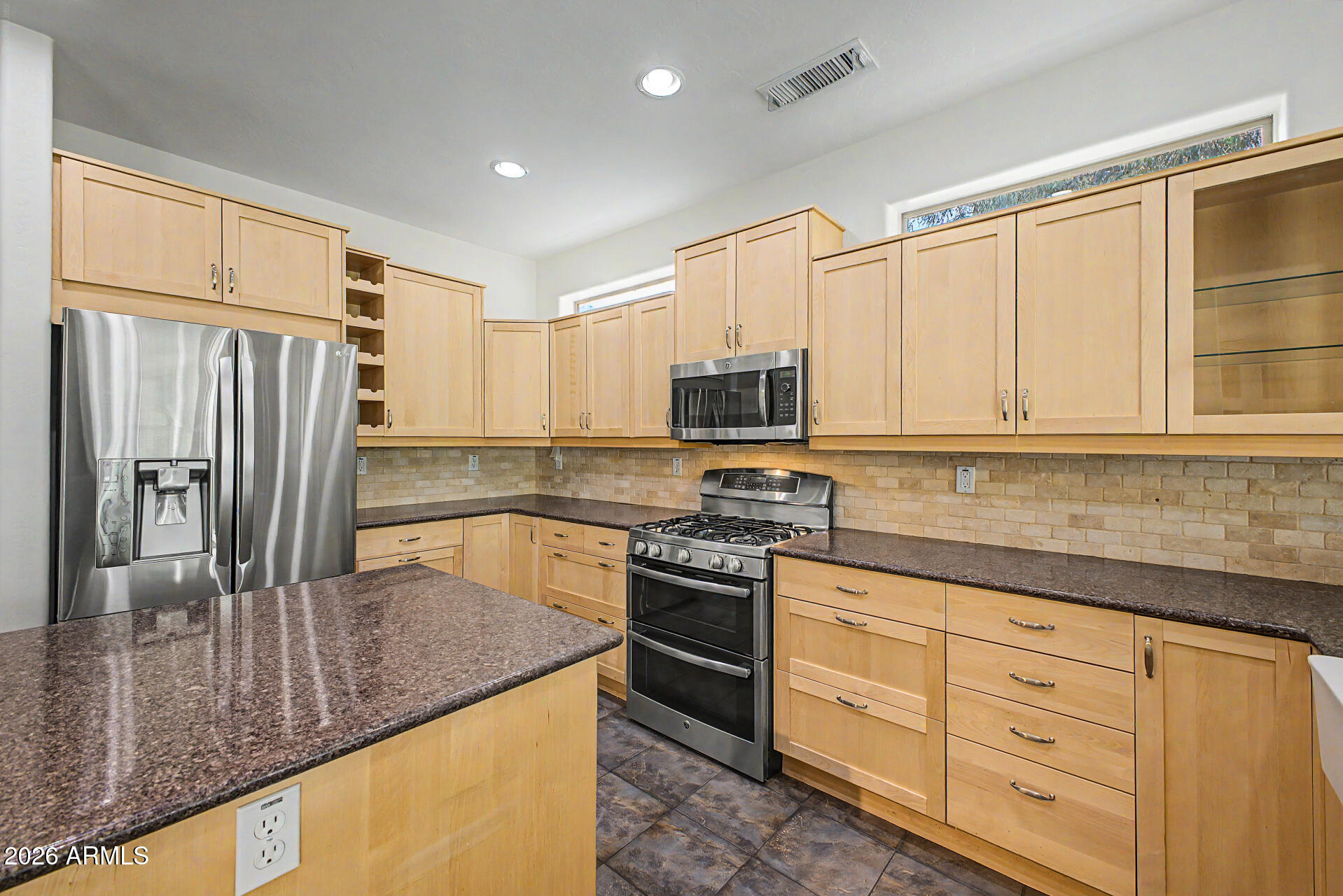 16731 West Oracle Rim Drive Surprise, AZ 85387 - Photo 21 of 54 a kitchen with stainless steel appliances granite countertop a sink a stove and refrigerator