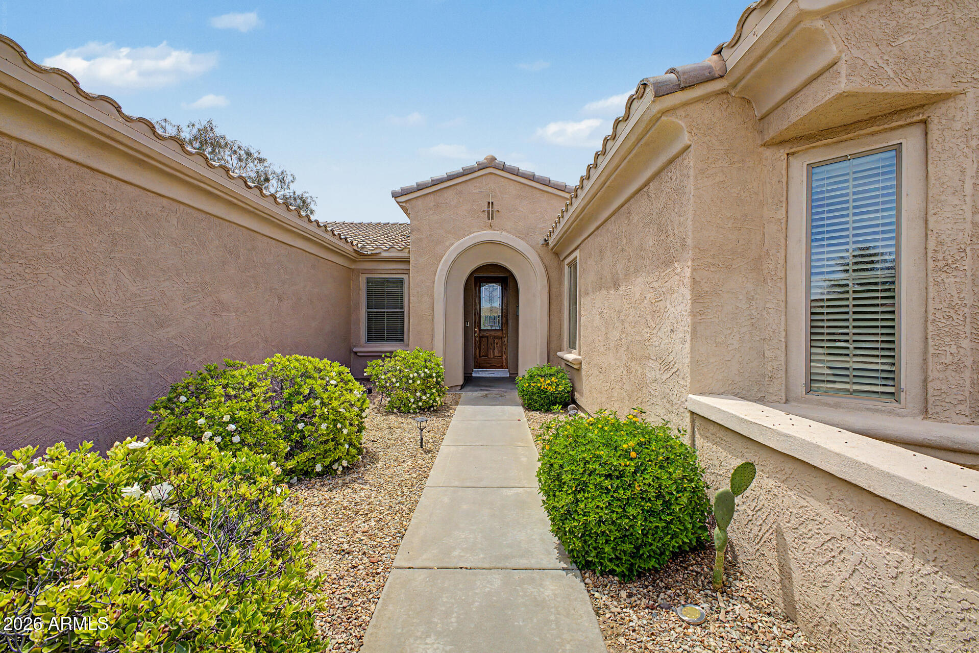 16731 West Oracle Rim Drive Surprise, AZ 85387 - Photo 3 of 54 a view of a pathway with a white house