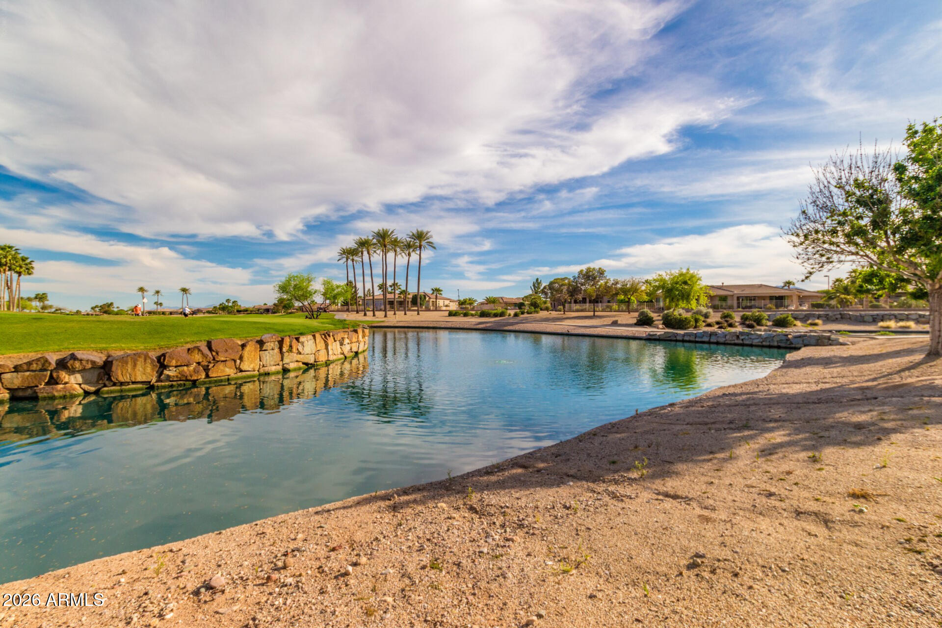 16731 West Oracle Rim Drive Surprise, AZ 85387 - Photo 43 of 54 a view of a lake with houses in the back