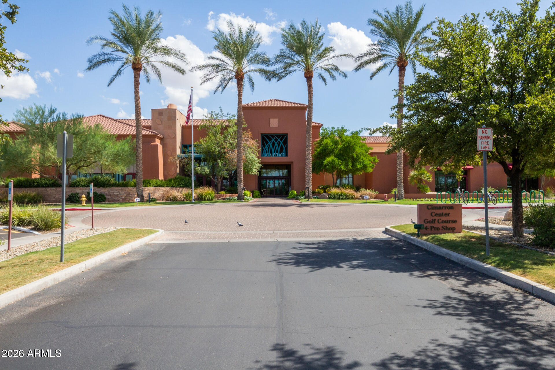 16731 West Oracle Rim Drive Surprise, AZ 85387 - Photo 48 of 54 a view of a building with a yard and palm trees