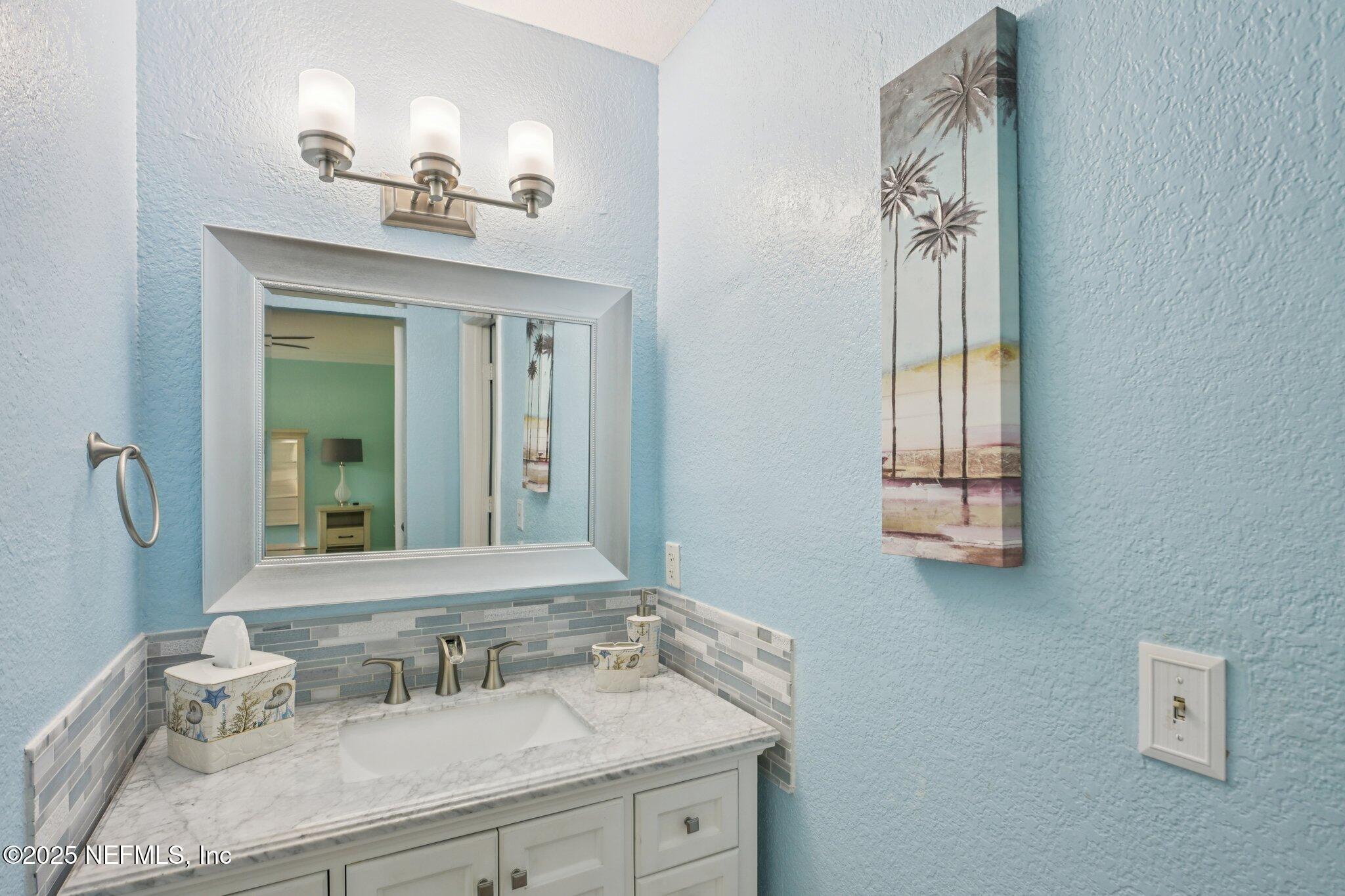 930 Seashell Lane Ponte Vedra Beach, FL 32082 - Photo 17 of 29 a bathroom with a sink and a mirror