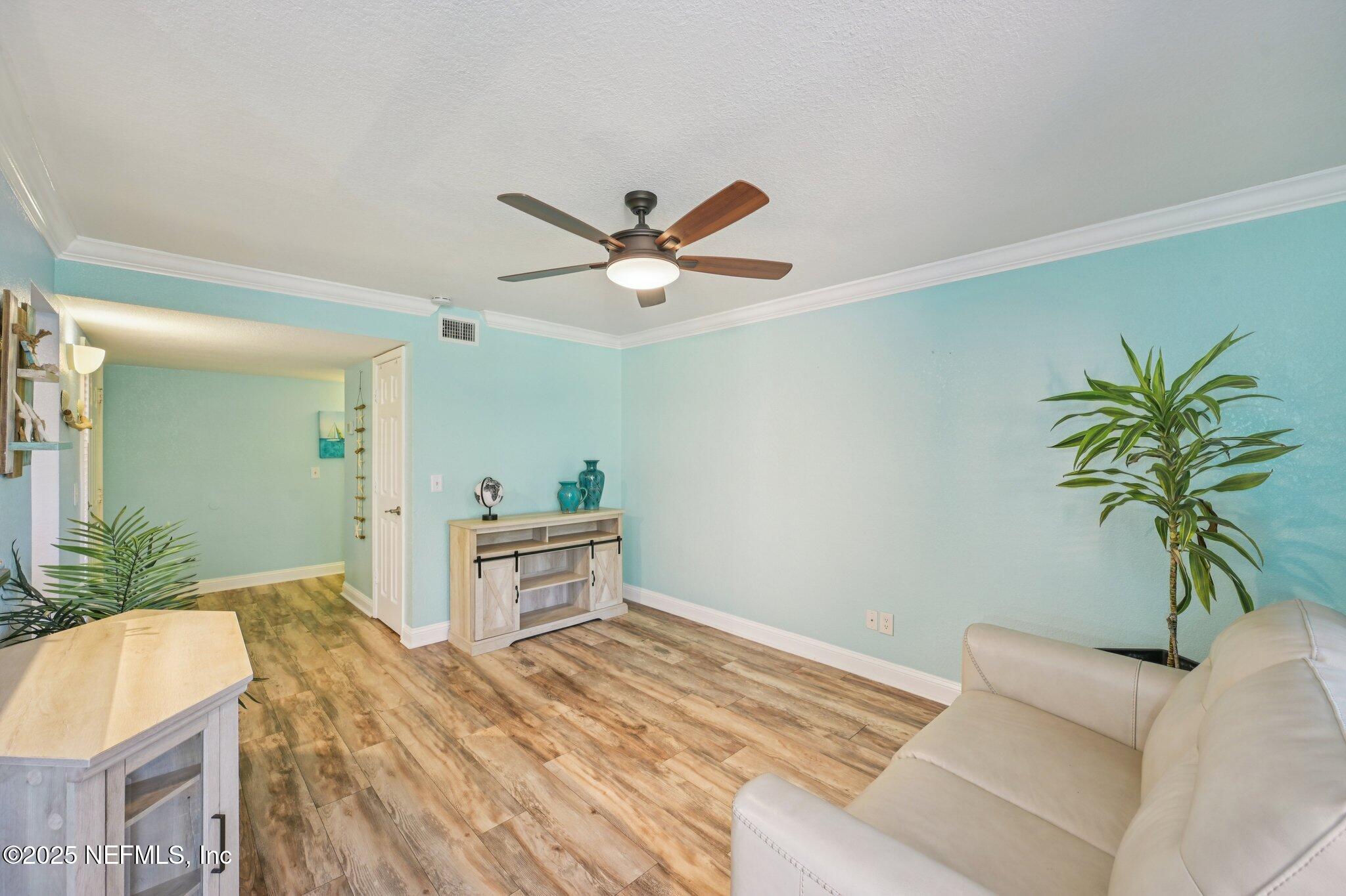 930 Seashell Lane Ponte Vedra Beach, FL 32082 - Photo 5 of 29 a bedroom with a bed and a chandelier