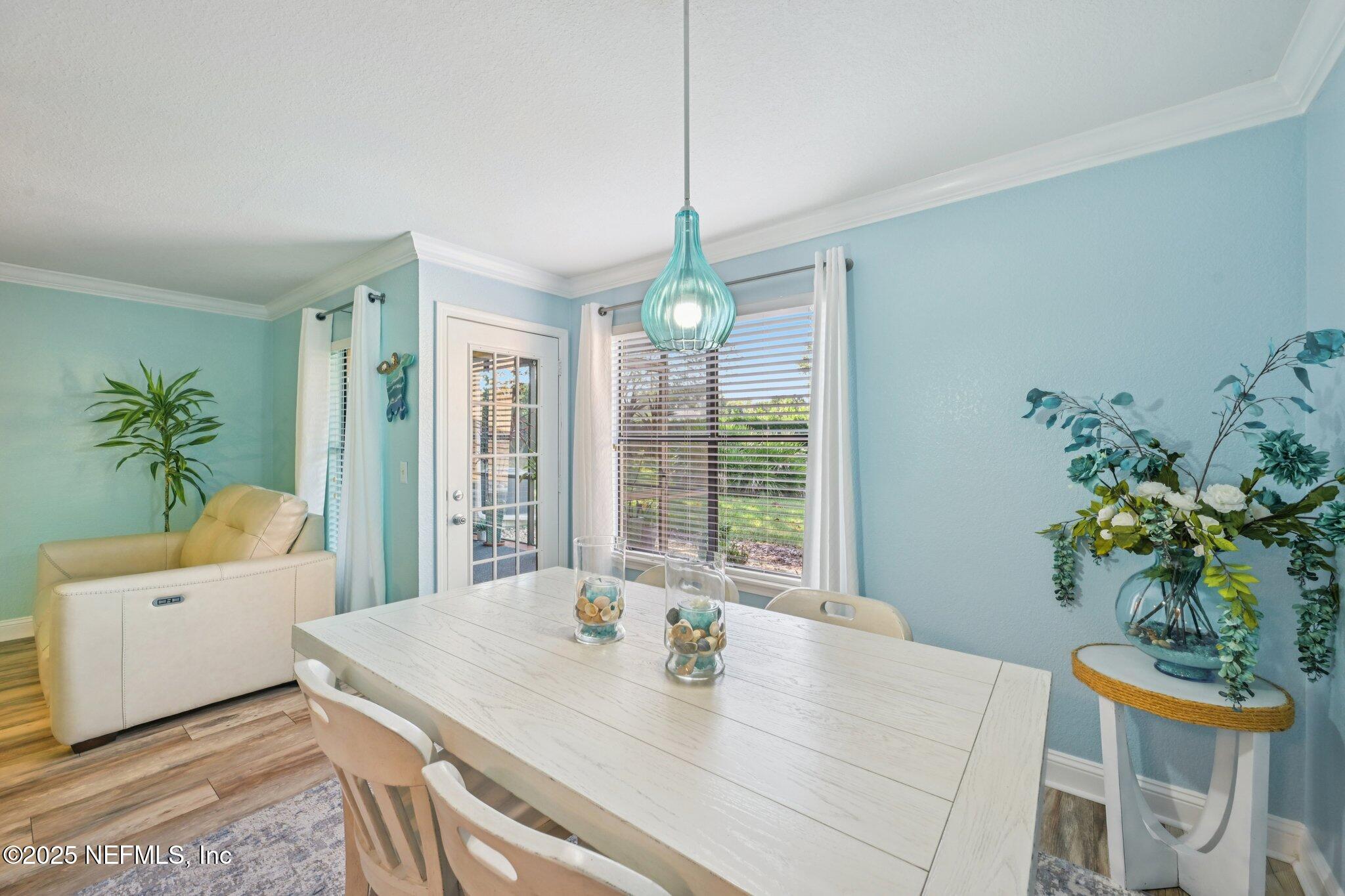 930 Seashell Lane Ponte Vedra Beach, FL 32082 - Photo 9 of 29 a dining room with furniture a potted plant and a chandelier