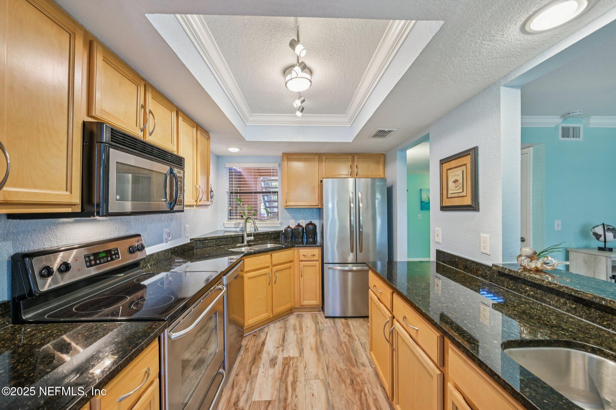 930 Seashell Lane Ponte Vedra Beach, FL 32082 - Photo 10 of 29 a kitchen with stainless steel appliances a sink stove and refrigerator