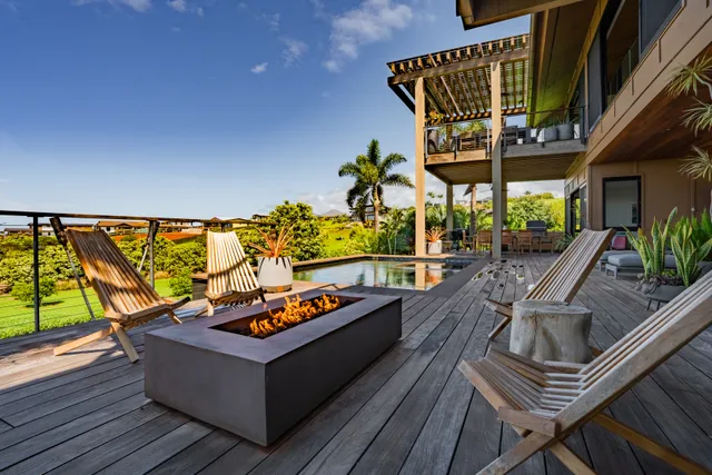 a living room with patio furniture and a potted plant