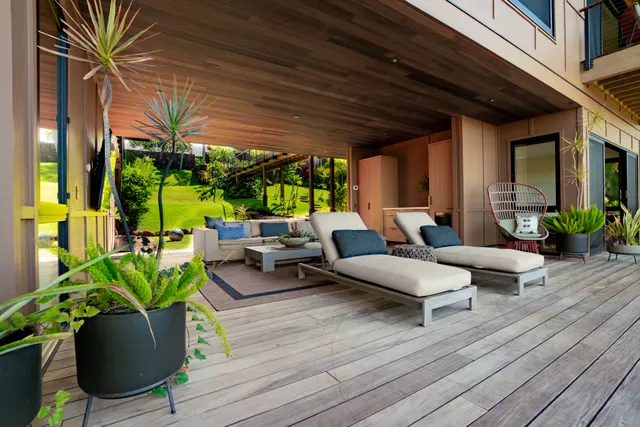 a living room with patio furniture and a flat screen tv