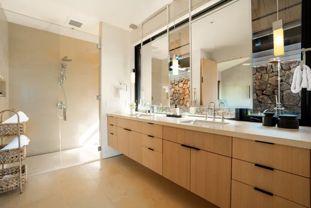 a large bedroom with a bed and wooden floor