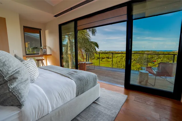 a bedroom with a large window and a bed