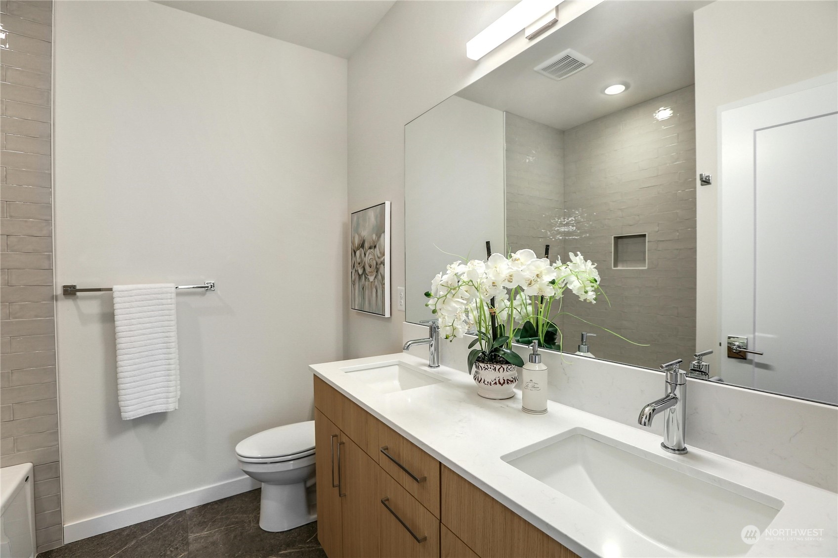 14493 Cedar Grove Road Southeast, Unit D101 Issaquah, WA 98027 - Photo 16 of 22 a bathroom with a toilet sink and mirror