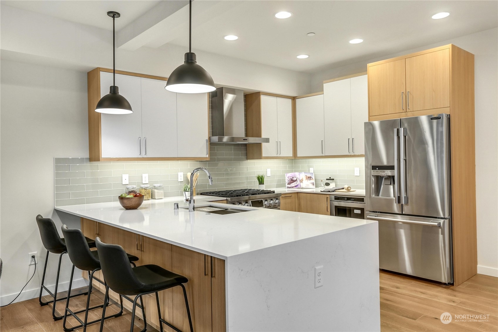 14493 Cedar Grove Road Southeast, Unit D101 Issaquah, WA 98027 - Photo 6 of 22 a kitchen with stainless steel appliances granite countertop a sink a stove a refrigerator and island with wooden floor