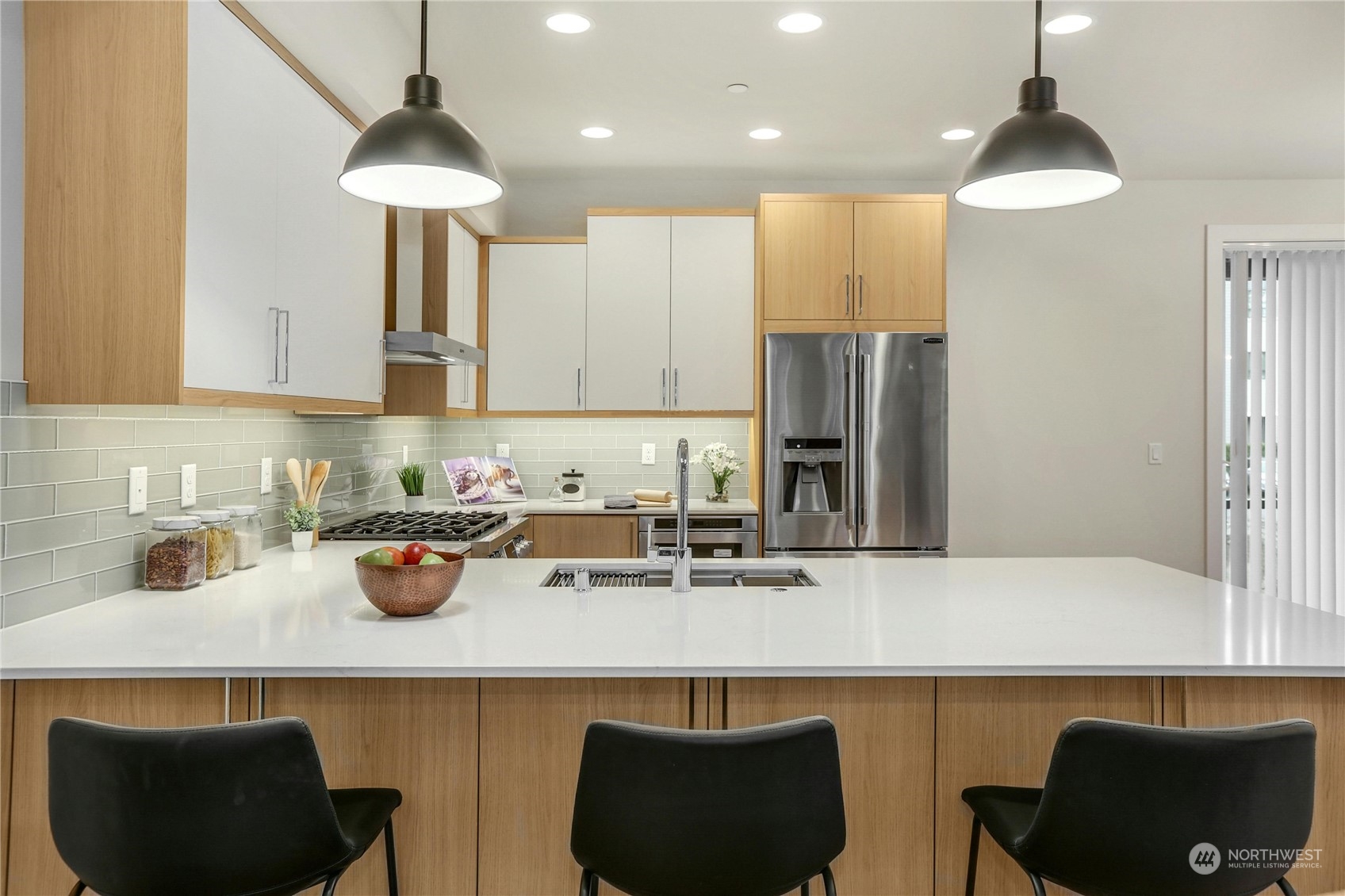 14493 Cedar Grove Road Southeast, Unit D101 Issaquah, WA 98027 - Photo 7 of 22 a kitchen with a sink a stove and chairs
