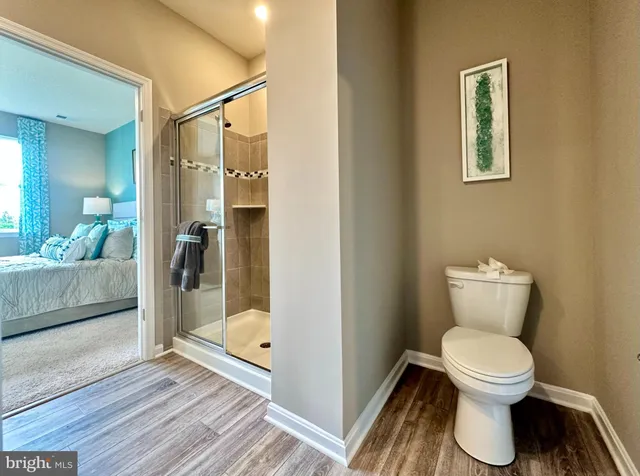 a bathroom with a toilet and a shower