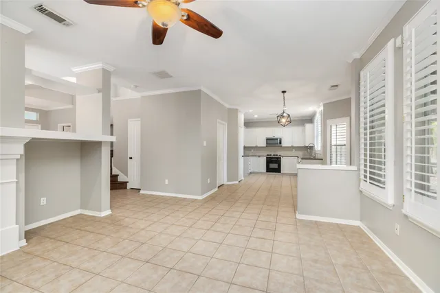 a view of kitchen with refrigerator and window