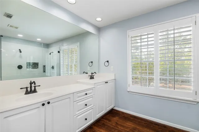 a view of bathroom with a sink mirror shower and vanity