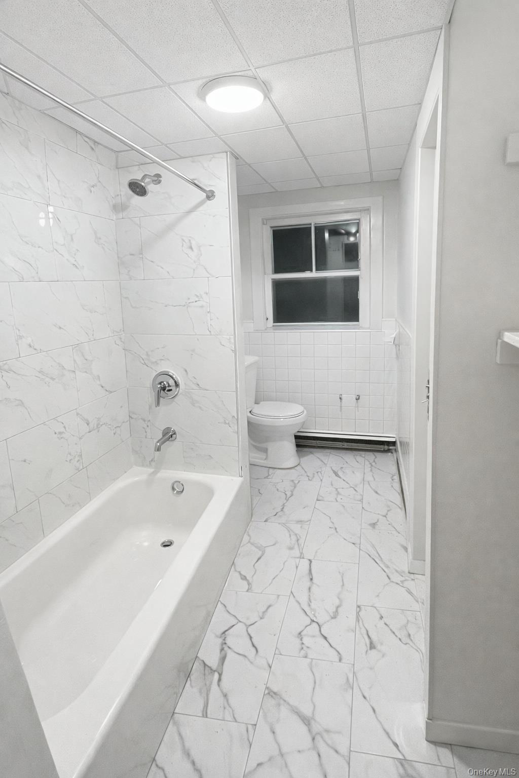 278 Mile Square Road Yonkers, NY 10701 - Photo 7 of 8 a bathroom with a bathtub and a shower